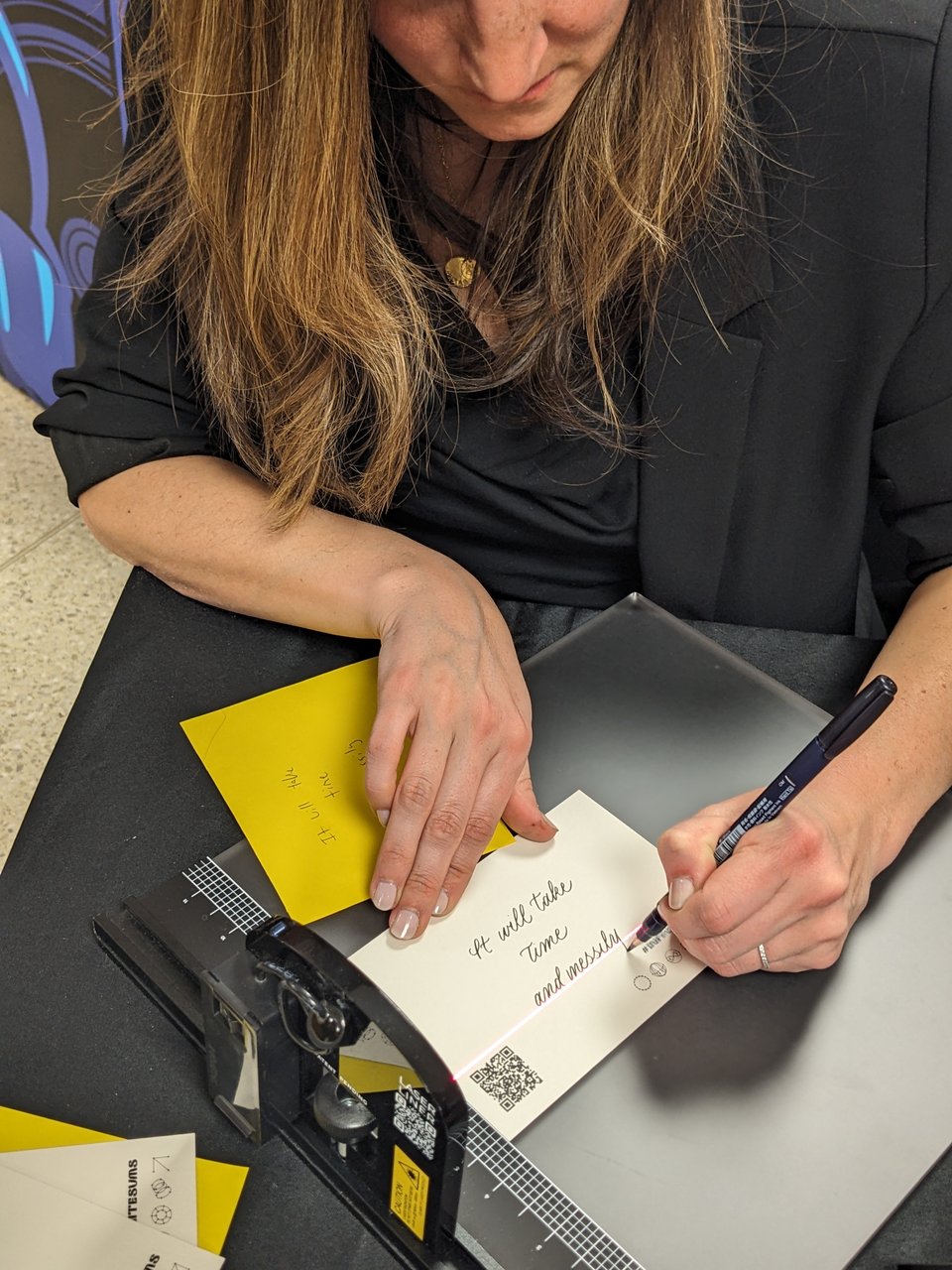 a person writing with a calligraphy tool "it will take time and messily"