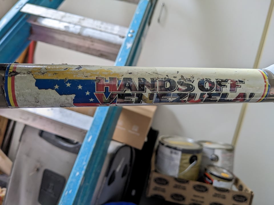 A bike sticker that reads Hands Off Venezuela