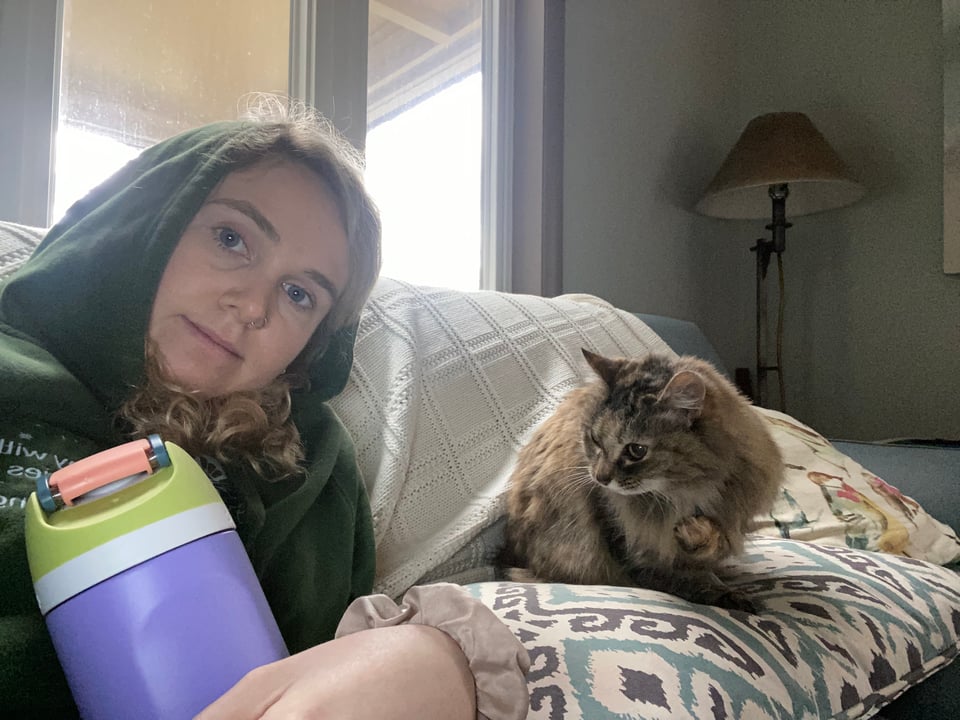 a girl with a cat and a water bottle