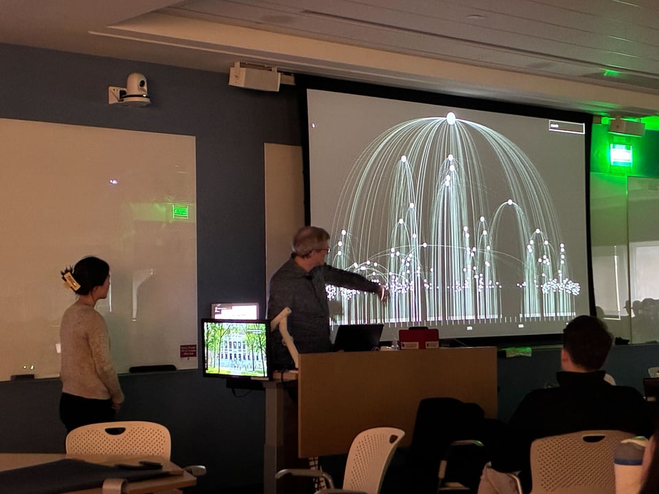 Katherine standing in front of a large projected image of Lookout explaining it to a class of students.