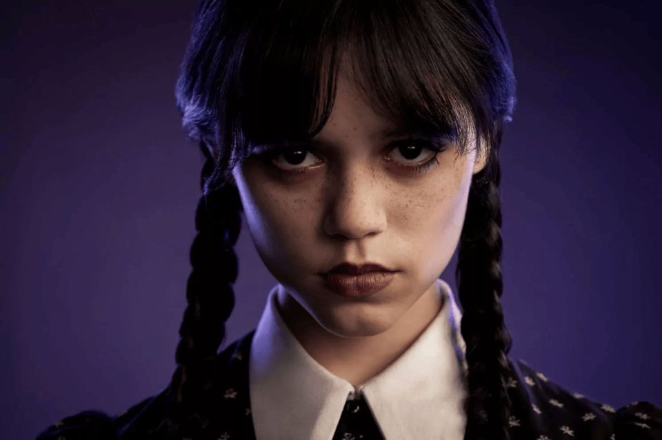 promo image for Netflix’s series Wednesday. Close up of Wednesday Addams (Jenna Ortega) looking right at the camera with a dead serious face