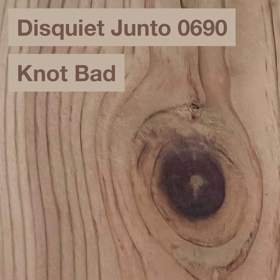 This is a picture of wood grain, with a big knot in it, plus the name and number of the project
