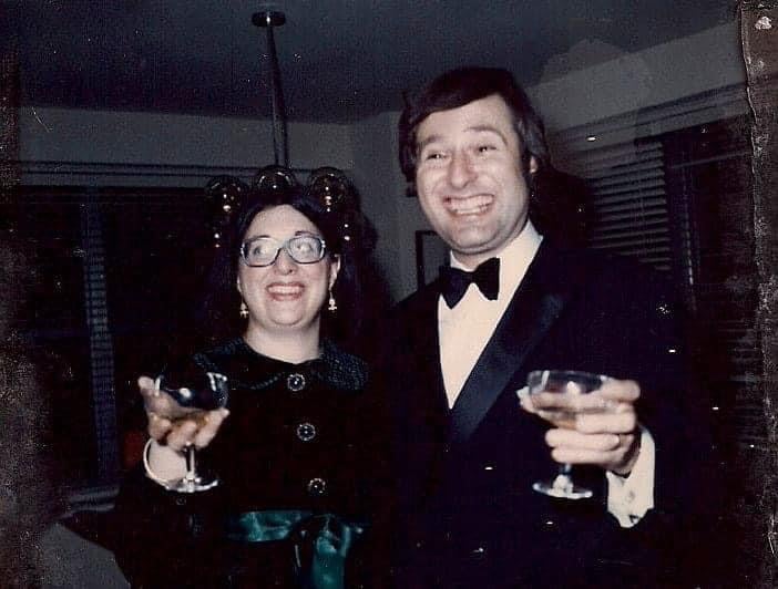 Man and woman raising coupe glasses of Champagne on New Year's Eve, 1971