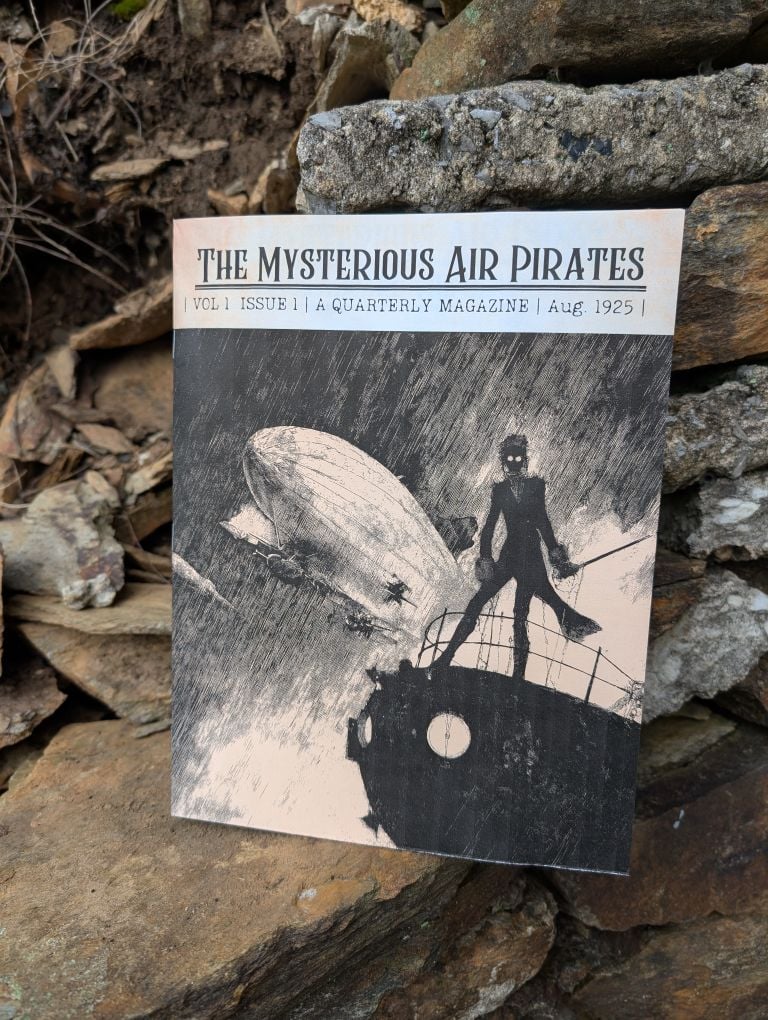 A copy of our air pirates magazine sitting on some rocks