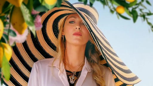 Another Simple Favor still. Blake Lively's character in an absurdly large hat.