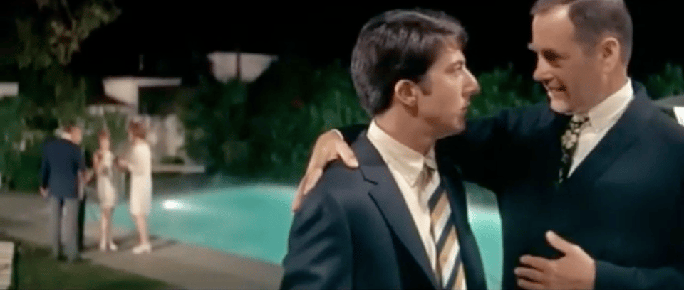 At a pool party. In the foreground, Dustin Hoffman's character listens to Mr. McGuire say "plastics."