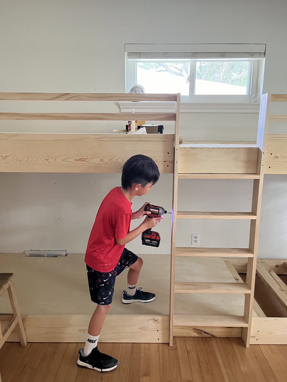 Our son helping finish ladder rungs