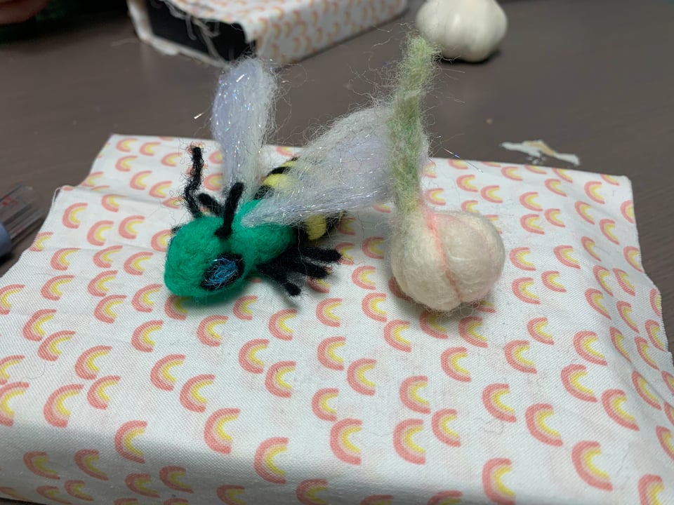 needle-felted bee and garlic figurines.