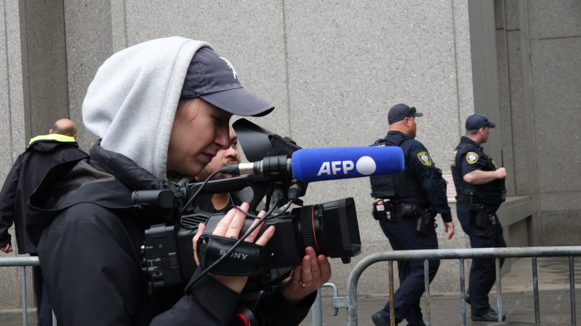 News crews and court officers outside the Manhattan federal courthouse during the Sean Combs racketeering trial, May 13, 2025.
