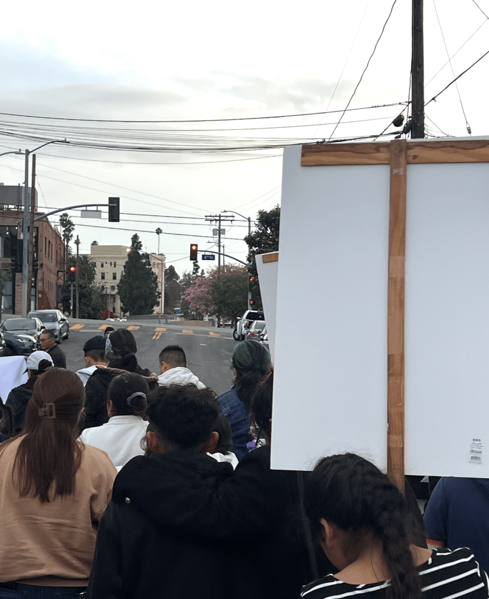 photograph of people walking down the street during a religious ritual