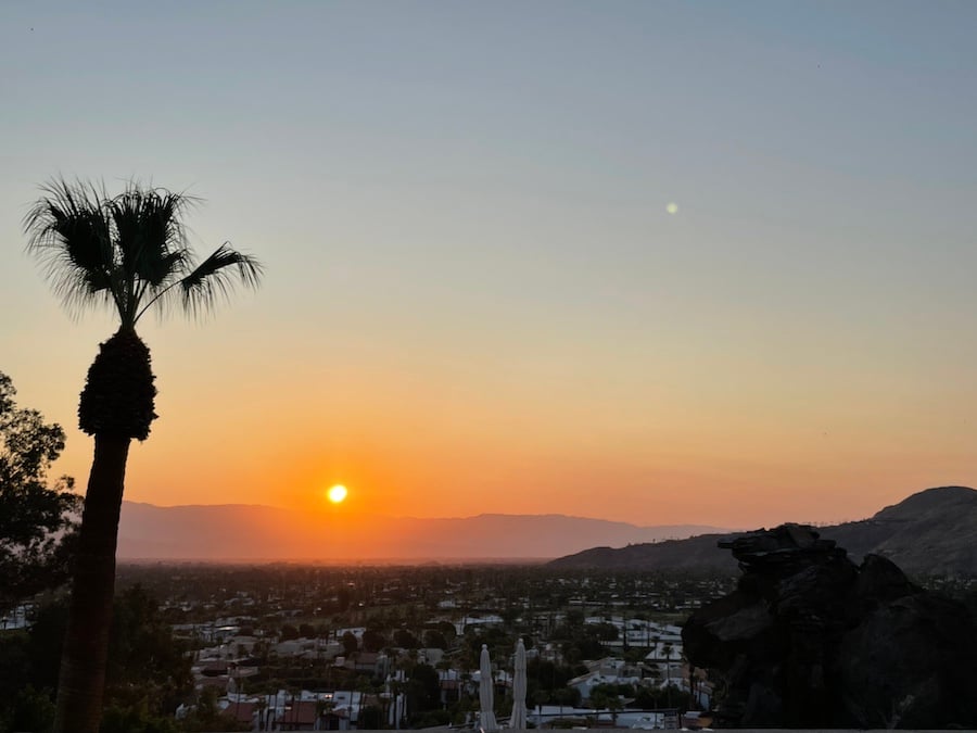 the sun setting over palm springs, california