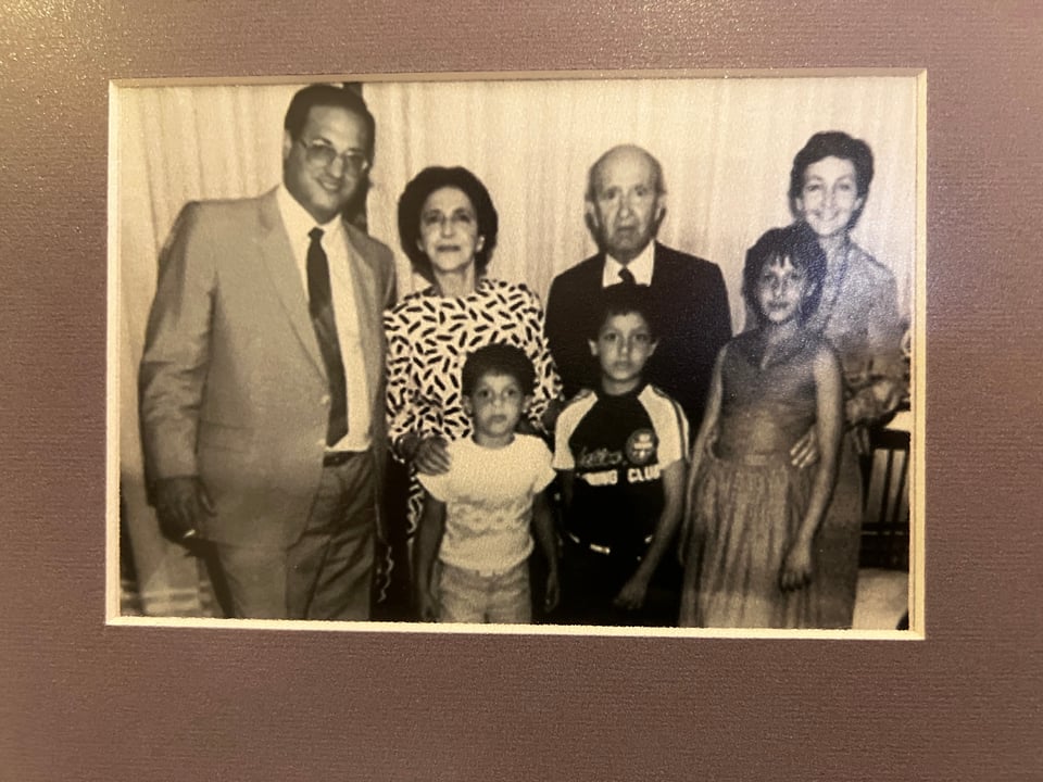 A black and white photograph of 4 adults and 3 children