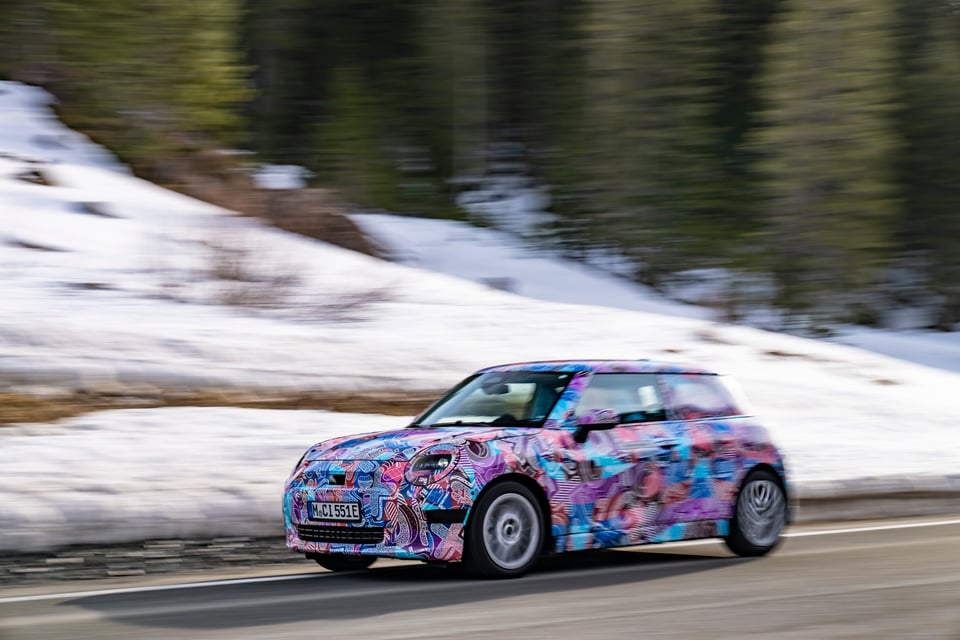 the new BMW Mini electric, in some fetching pastel colours, driving through the snow