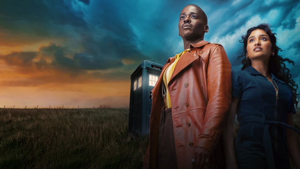 Ncuti Gatwa and Varada Setthu standing in front of the TARDIS