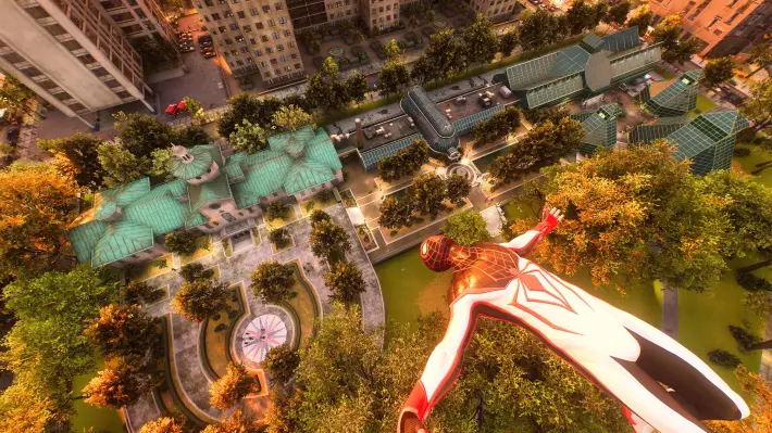 A screenshot from the video game Spiderman 2, in which Spiderman is soaring through the sky, facing upwards with his arms out and horizontal, high above the Brooklyn Botanic Garden. Far beneath him is a large gabled antique building with a large old fashioned garden, and dozens of trees