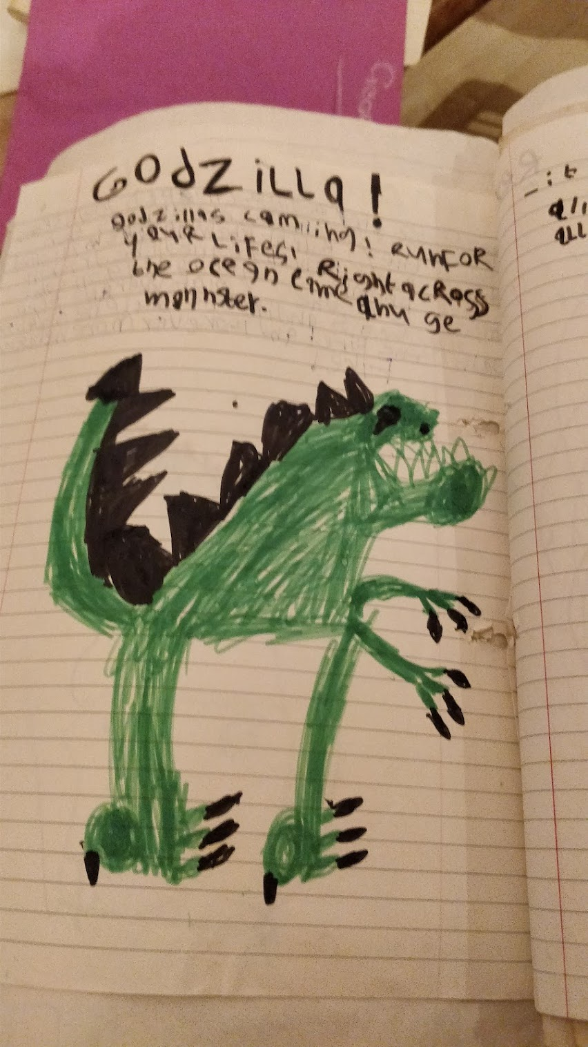 A child's drawing of Godzilla, with some words telling a brief story about the monster