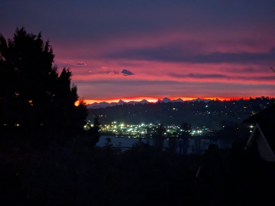 Surrey, B.C. skyline at sunset, filled with muted pink and orange.