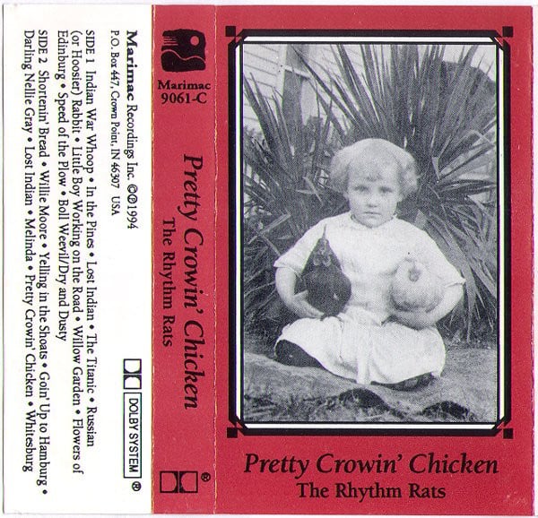 Tape sleeve for "Pretty Crowin' Chicken" by the Rhythm Rats. The cover is red, with a black and white photograph of a small child holding a chicken under each arm.