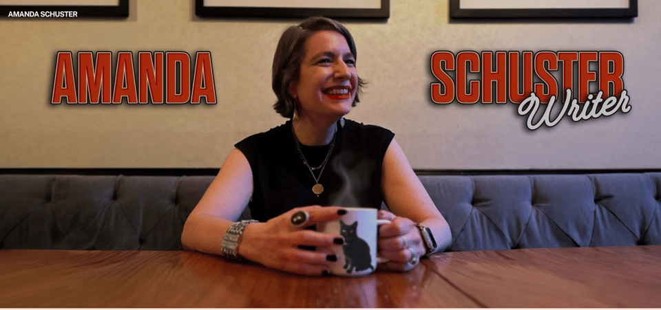 AMANDA SCHUSTER WRITER banner for amandaschuster.com with the author and a mug of steaming liquid