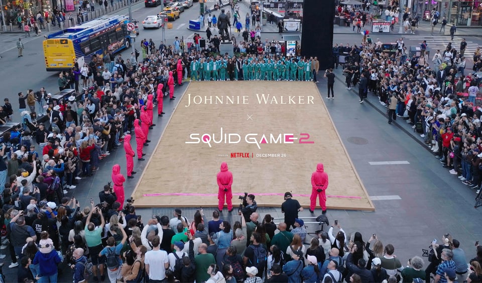 a crowd of people watch a game of Red Light, Green Light