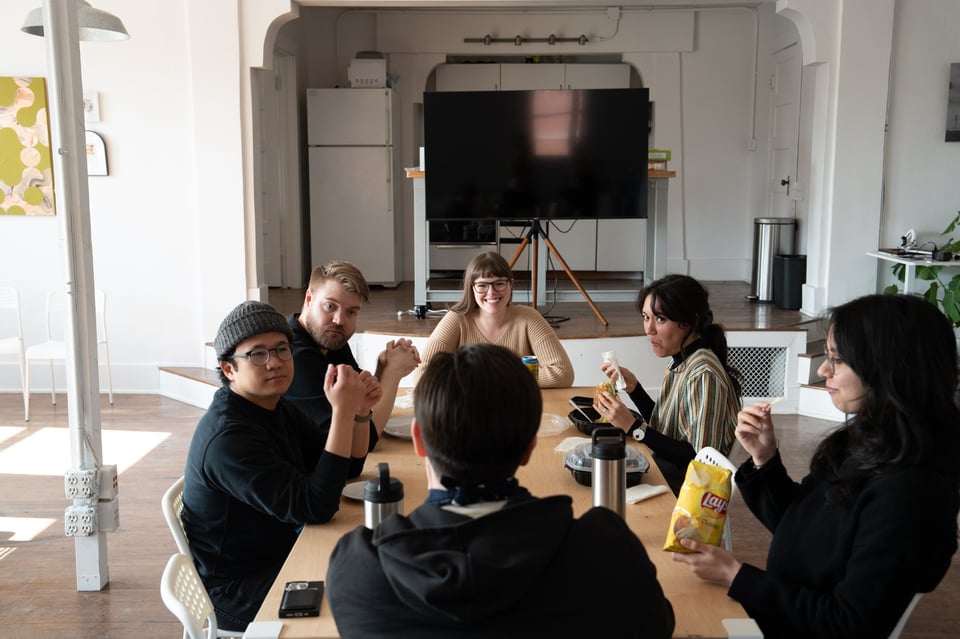A group of people sitting around a table.