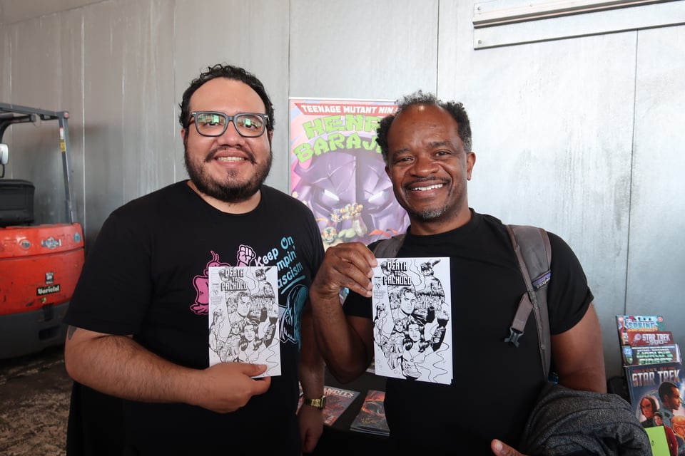 two men holding comic books