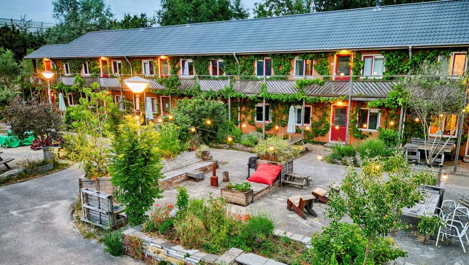 Picture taken from above of the Amsterdam Farm Lodge. Apartments, lights, greenery.