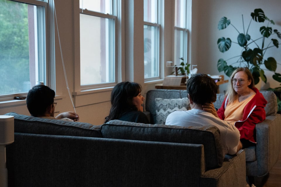 A similar group talking at some couches.