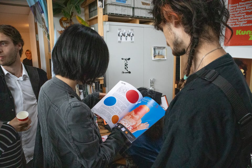 Two people read a magazine