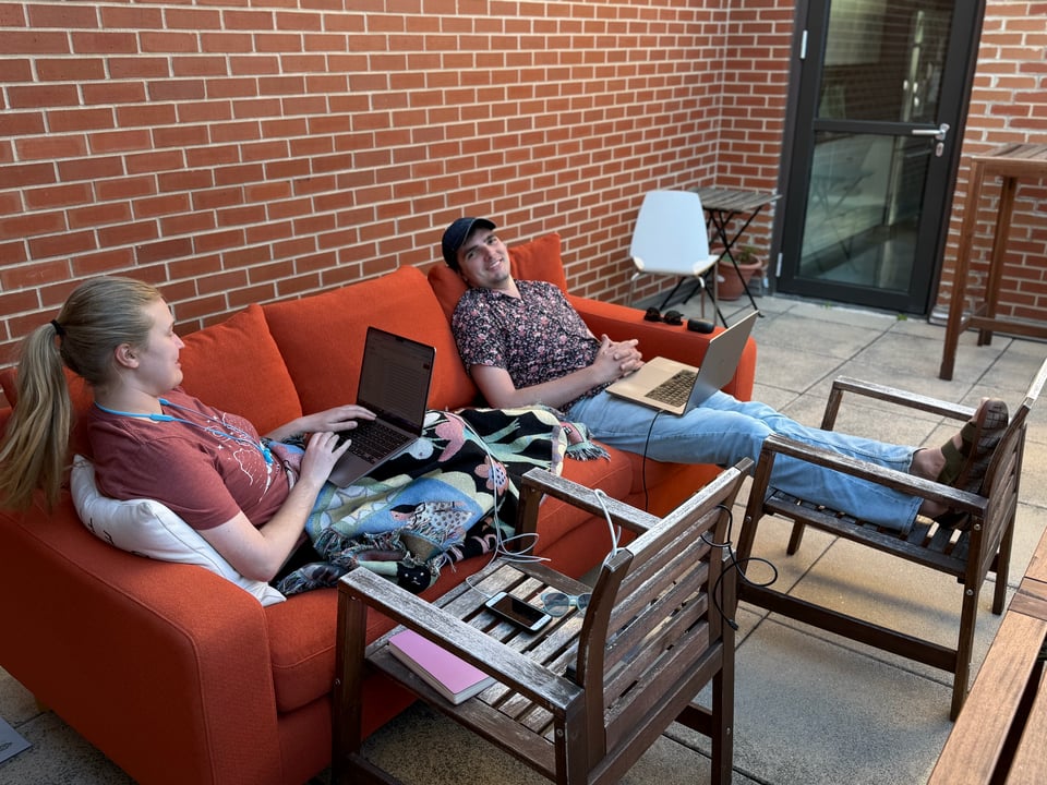 Ellory and Paul working on a couch on the patio