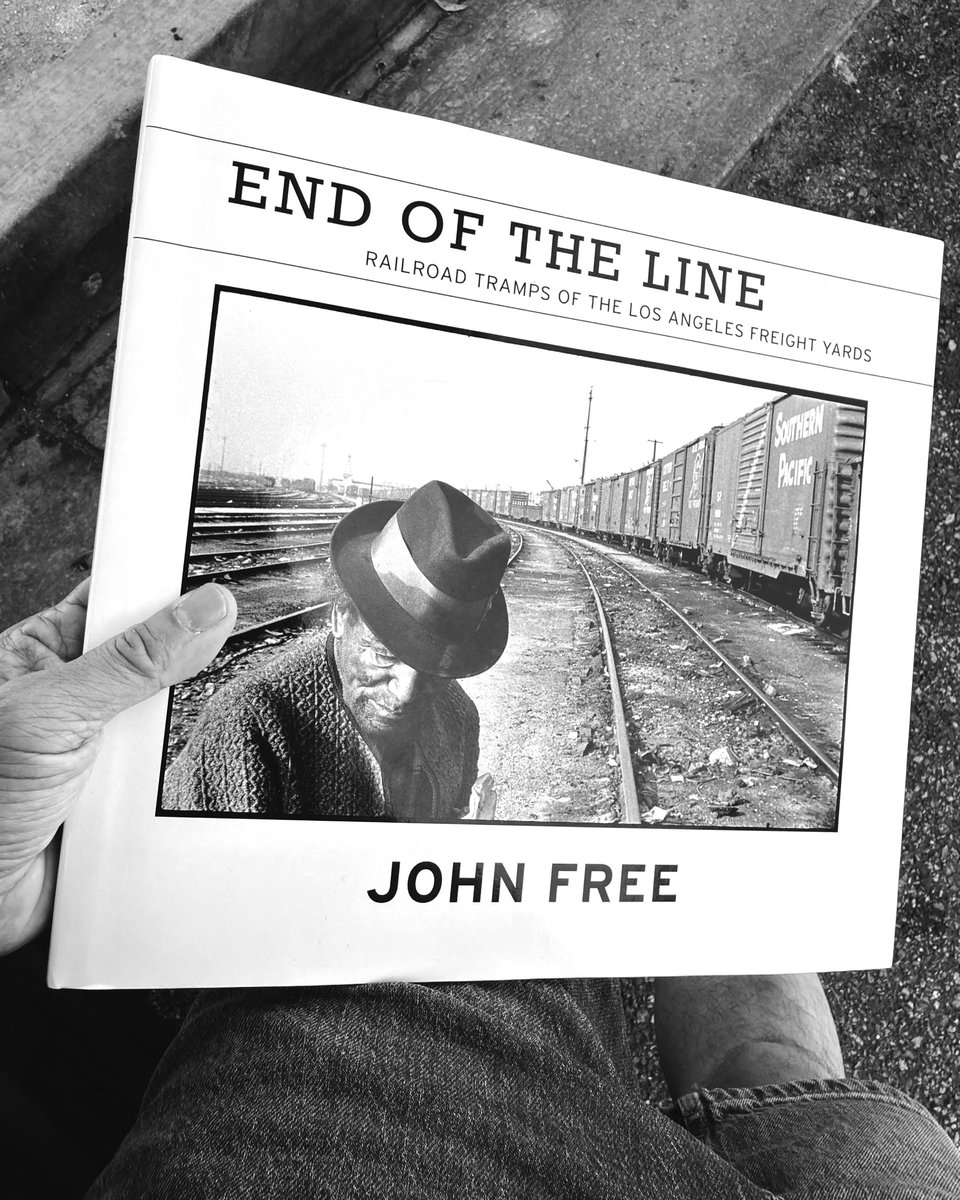 Photo of my hand holding a copy of John Free's photo book "End of the Line."