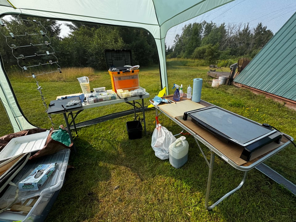 Leslie's screen room studio up north - two tables with trays and a heated palette for encaustic