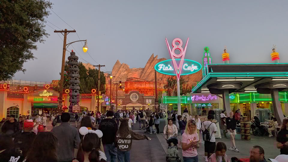 Cars Land at Disney California Adventure, at dusk with the neon lit.