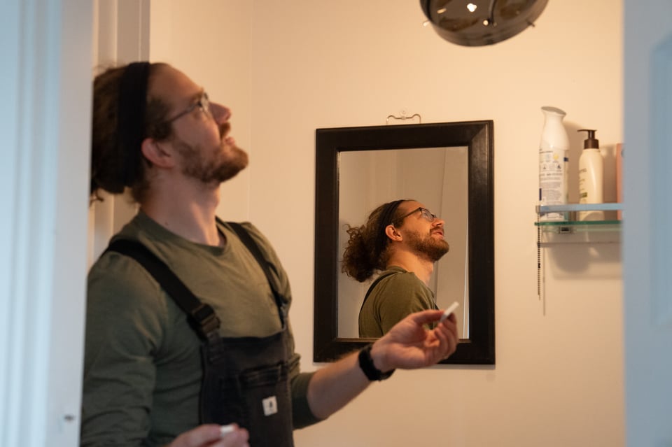 Jim looking wondrously at a lightbulb.