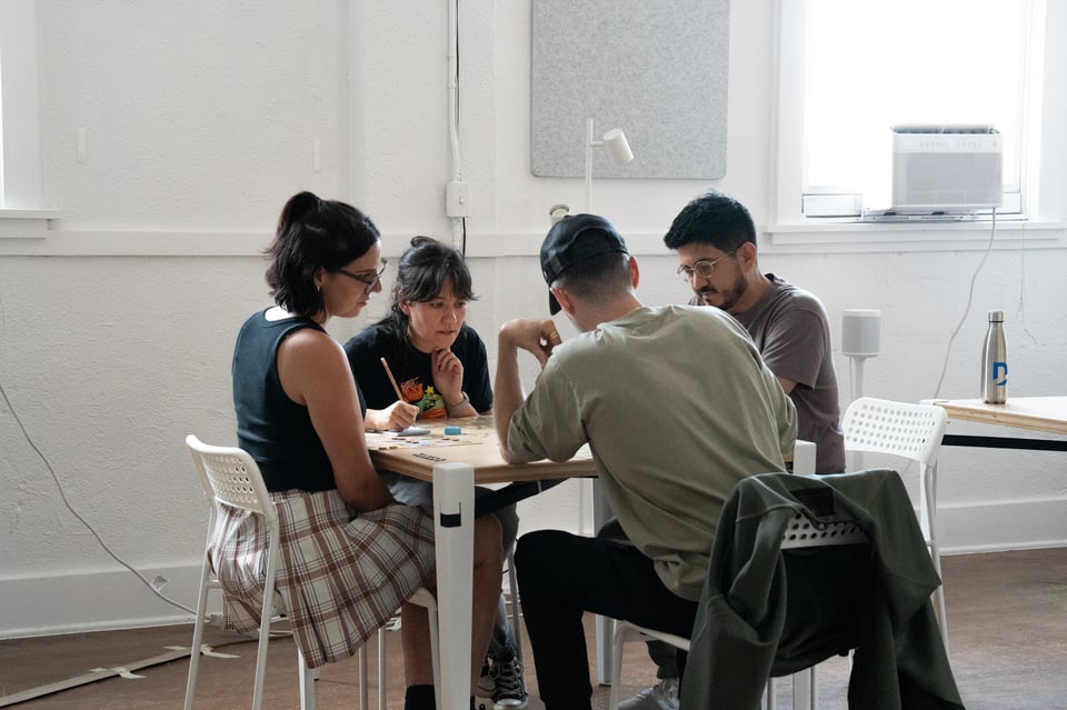 People playing a board game at a table.