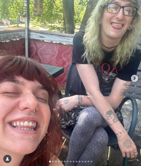 Bottom left, the singer, a young person with a huge easy smile; right, the percussionist, also smiling, toung between teeth, legs crossed, seated on what appears to be a cafe chair. I'm not exactly sure how, but it appears that the table they're seated at is in a treehouse?