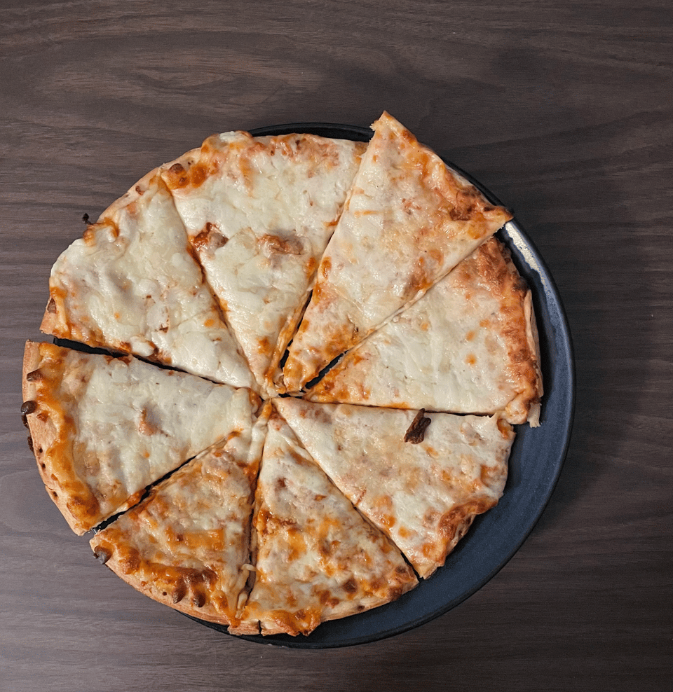A poorly cut cheese pizza with a noir-like shadow