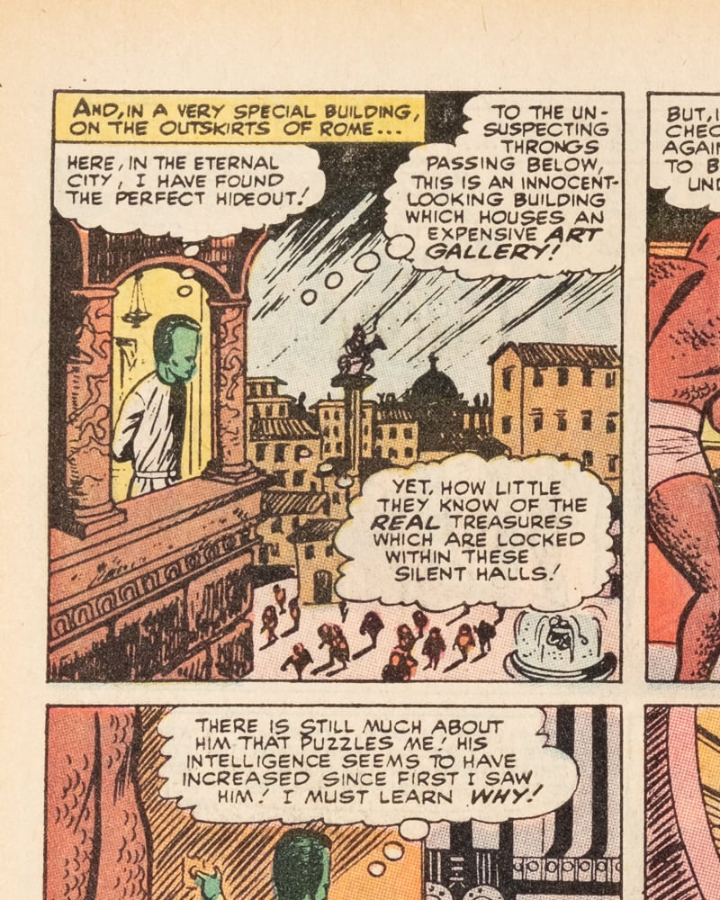 The Leader is looking out over a Roman plaza. His thought bubble reveals that his hideout is in a disguised art gallery