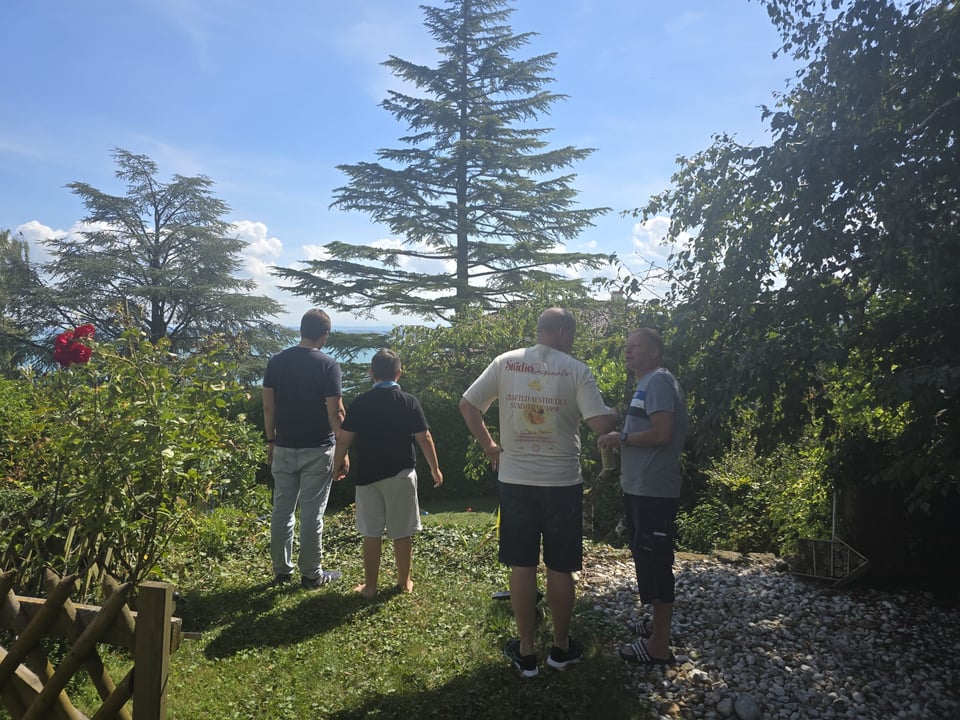 Four people overlooking a garden