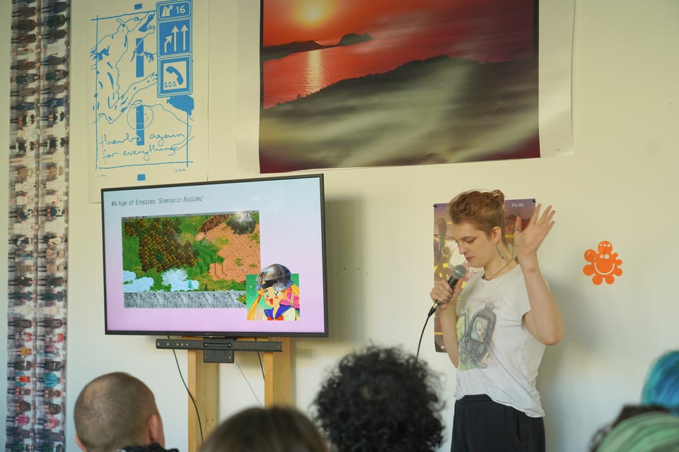 A presenter gestures dramatically while speaking