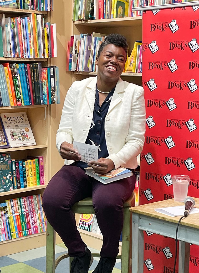 author Phoebe Sinclair smiles in a bookstore