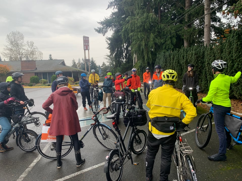 Tour attendees with bikes look at a point of interest near 148th St. in Shoreline.