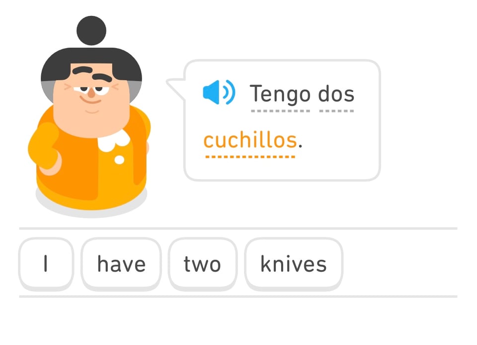 A screenshot of the program Duolingo. A woman proudly says in English and Spanish: I HAVE TWO KNIVES