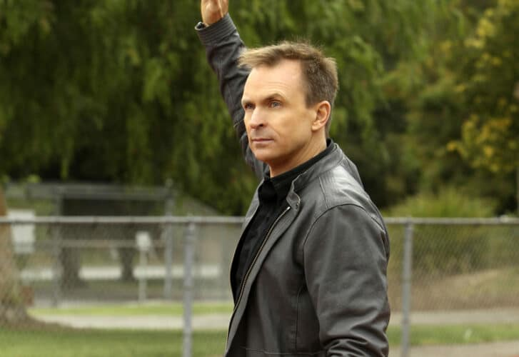 Phil Keoghan raising his arm in the air