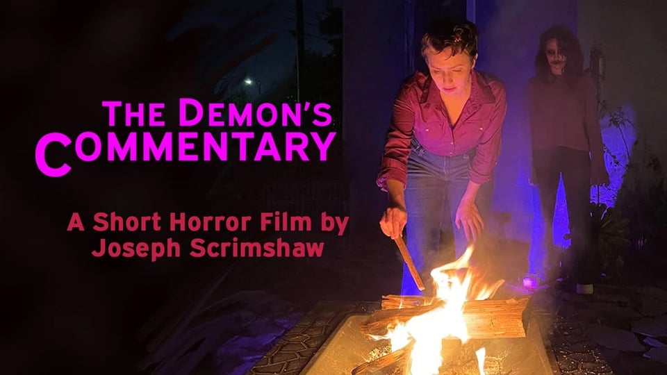 A woman leans over a fire pit, poking at the flames, behind her a demonic figure lurks in the dark purple shadows