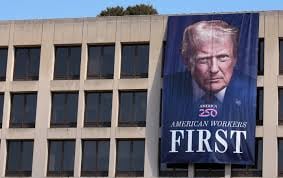 A photo of President Donald Trump is displayed on the side of the US Department of Labor on August 25, 2025, in Washington, DC.(Kevi