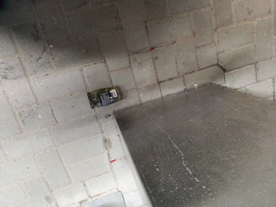 Floor pickles. A jar of pickles on the floor.