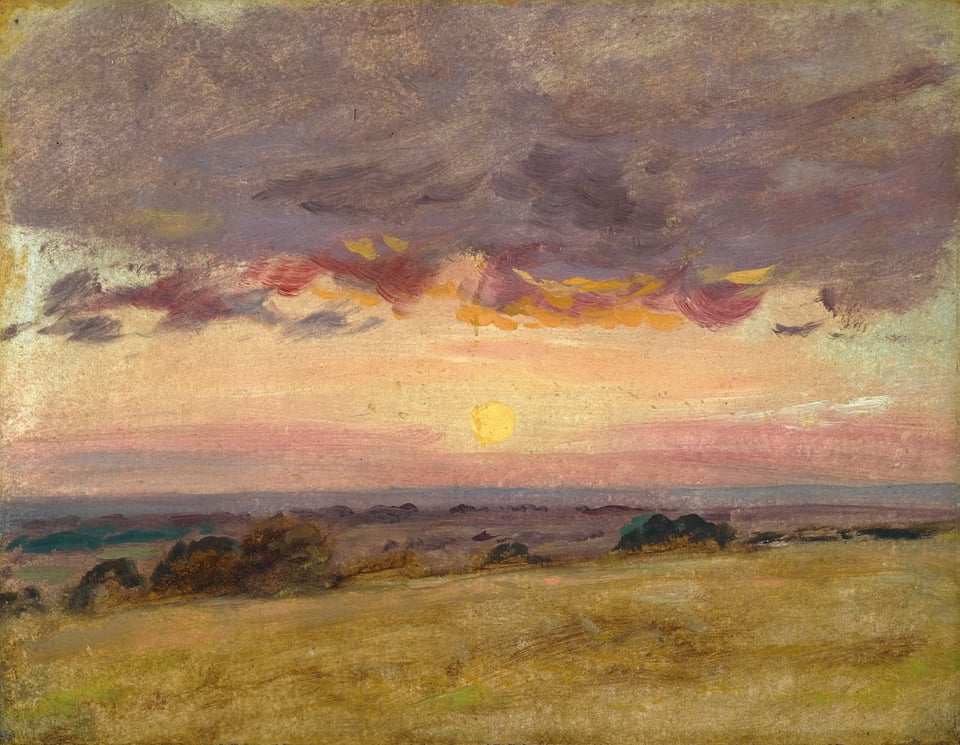 a sunset over a field