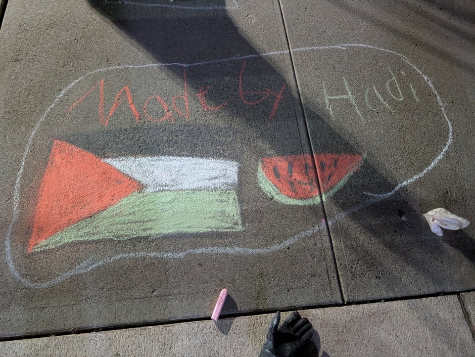 A chalked Palestinian Flag and watermelon slice, signed by the artist Hadi