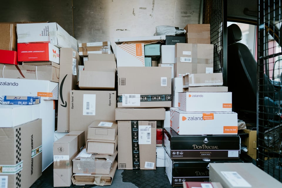 A delivery truck full of packages. Photo by Claudio Schwarz on Unsplash.